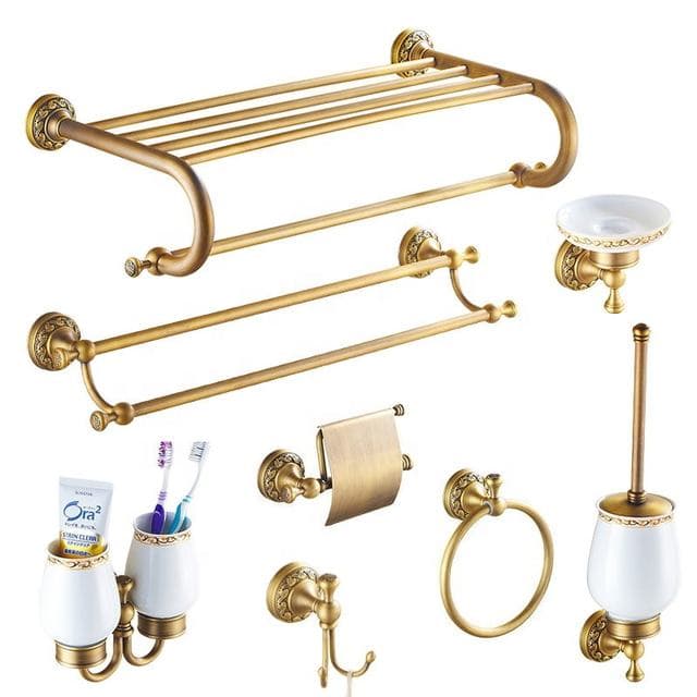 Gold bathroom accessory set with towel rail, paper holder and brush holder