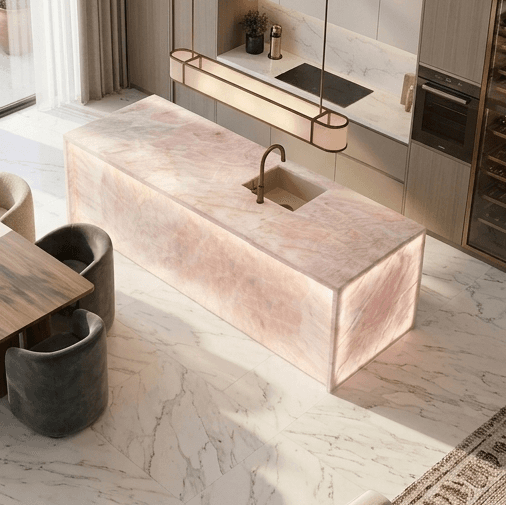 Backlit translucent quartzite island in a pale pink stone finish