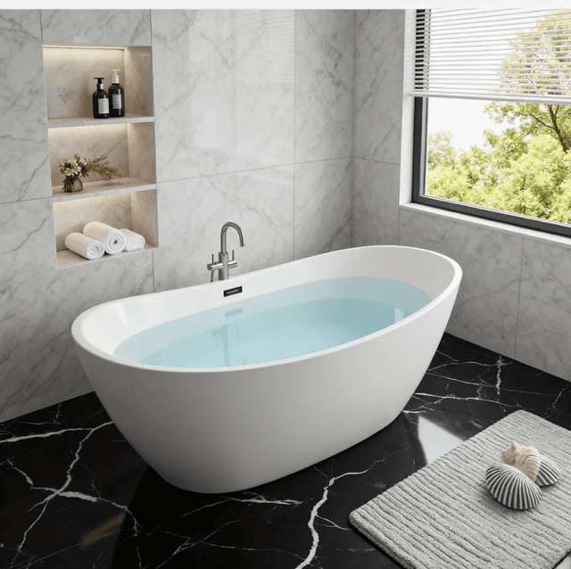 Boat-shaped freestanding bathtub with a raised reclining backrest at one end, view 2