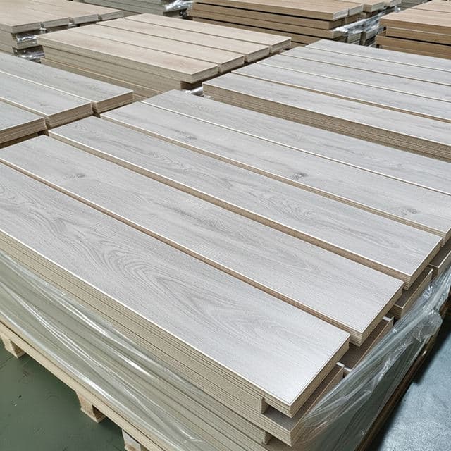 Packs of SPC flooring stacked in a warehouse