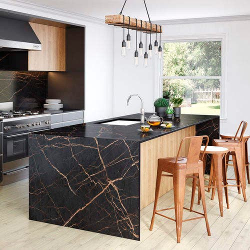 Waterfall island in a kitchen with dark veined stone and wooden bar stools