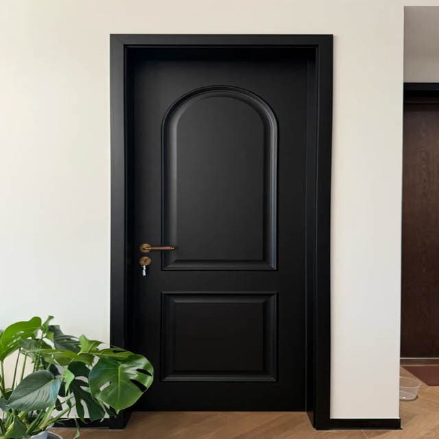 Black interior door with an arched panel