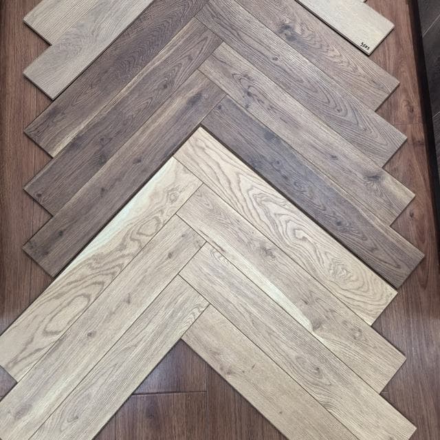 Herringbone parquet flooring in mixed wood tones