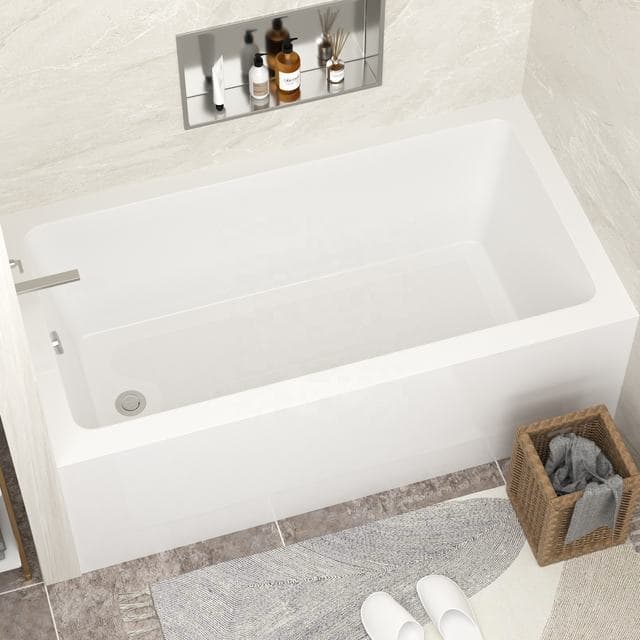 Freestanding white acrylic bathtub with centre drain and a floor-mount filler